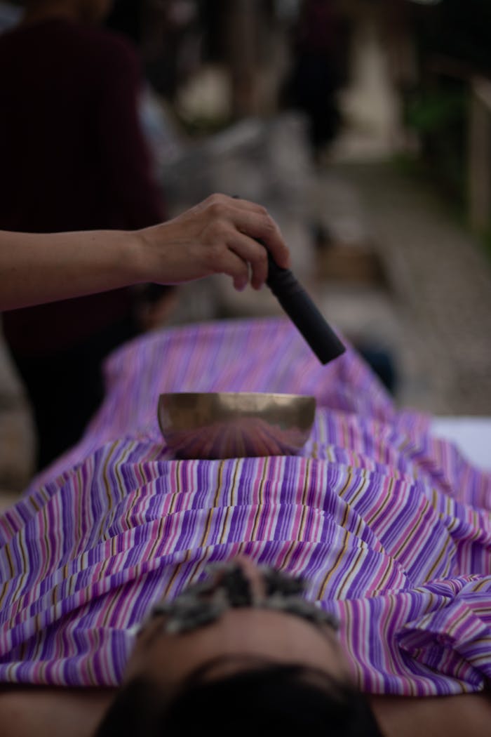 A tranquil sound therapy session using a singing bowl in a spa for relaxation and well-being.